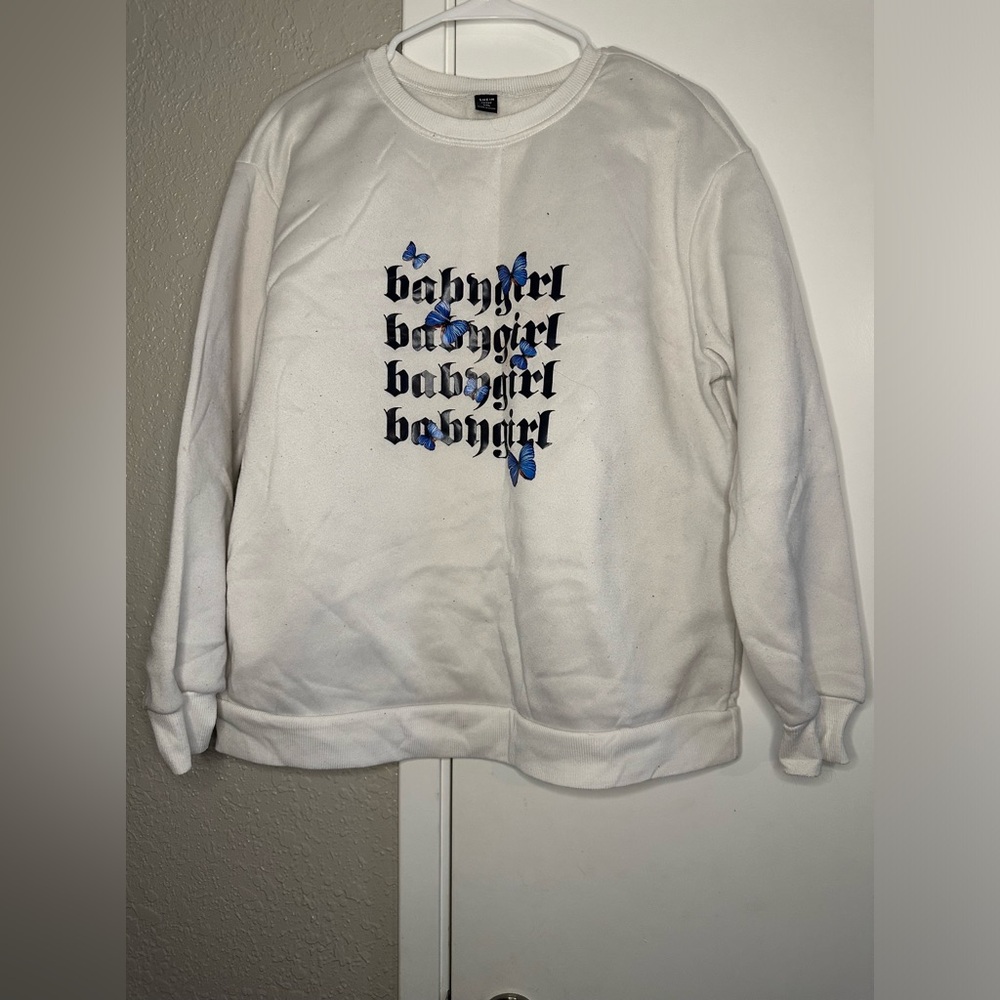 Light sweater with babygirl and butterflies on front logo.
